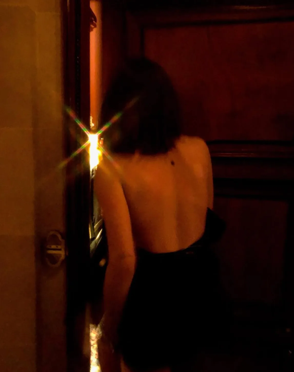 Figure at a doorway, light breaking through